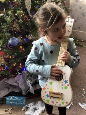 Girl Playing Toy Guitar